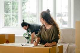 Couple with pile of boxes preparing to relocate